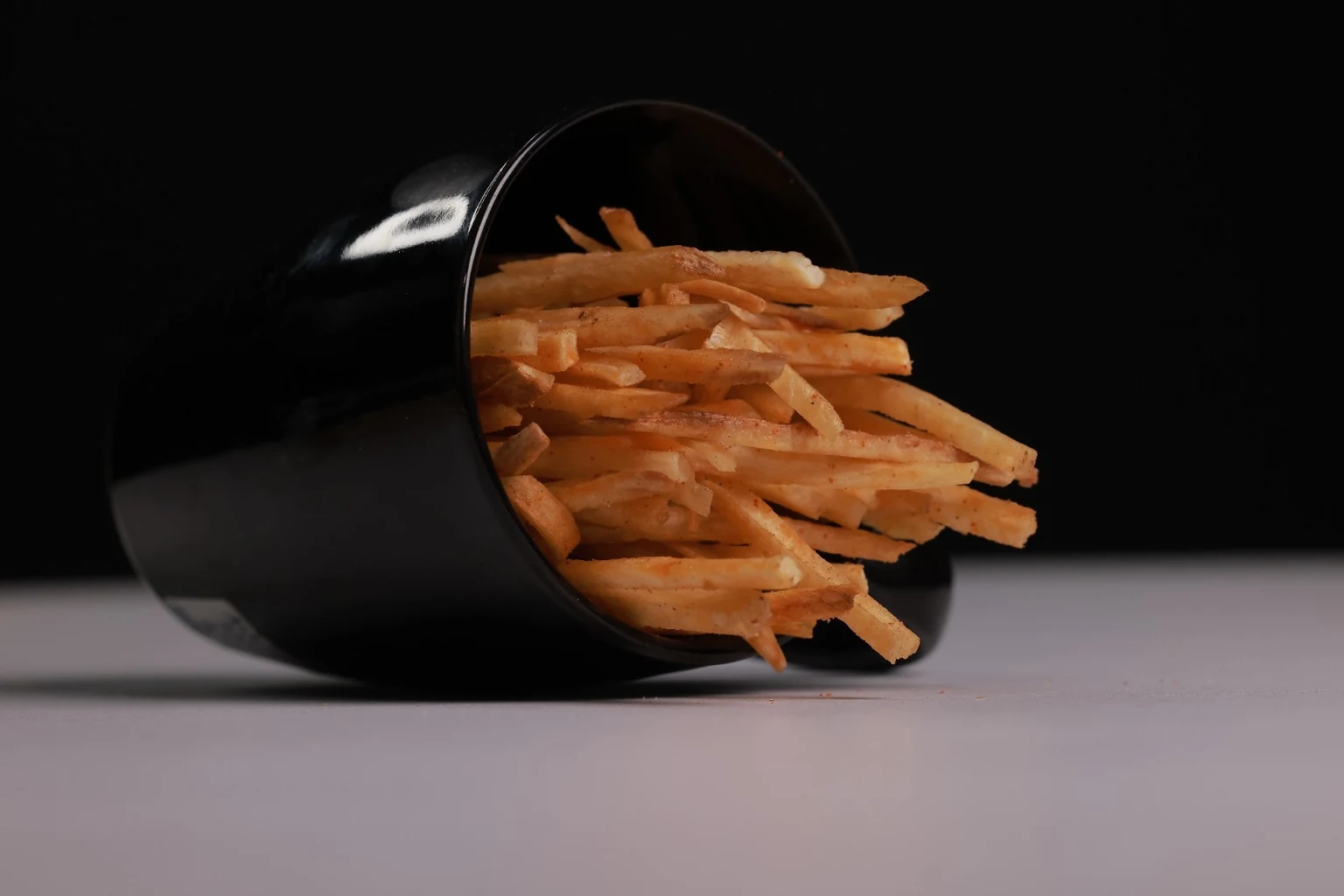 Tapioca stick chips in a black bowl, supplied KK Chips product photograph